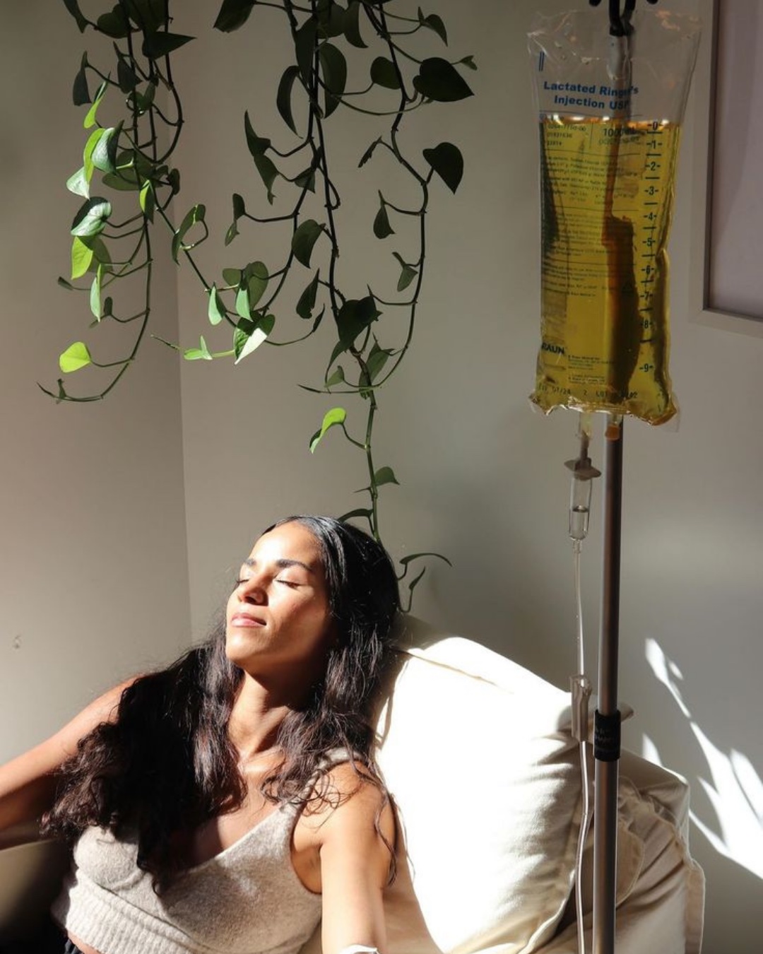 A client relaxing in warm sunlight during a mobile IV therapy session